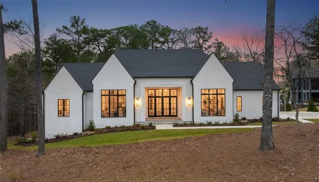 a front view of a house with a yard and outdoor seating