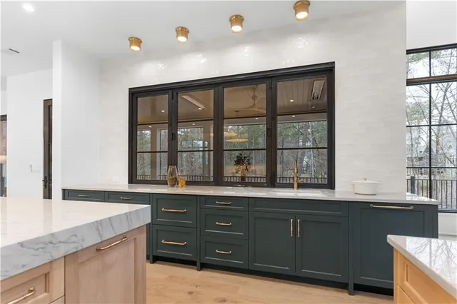 a very nice looking room with a large window and chandelier