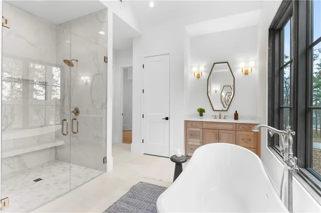 a view of an empty room with a window and a kitchen