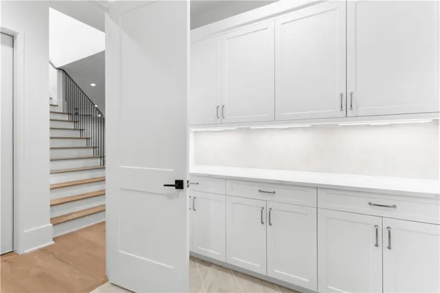 a view of an empty room with a fireplace and windows