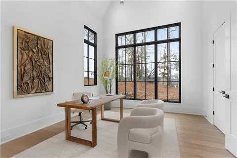 a large kitchen with granite countertop a sink dishwasher a dining table and chairs with wooden floor