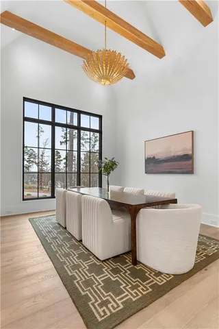 a living room with furniture a chandelier and a fireplace