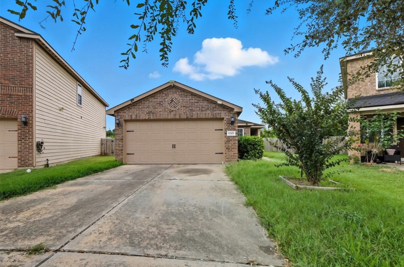11203 Hall Ridge Court Houston, TX 77075 - Photo 3 of 21 a front view of a house with garden