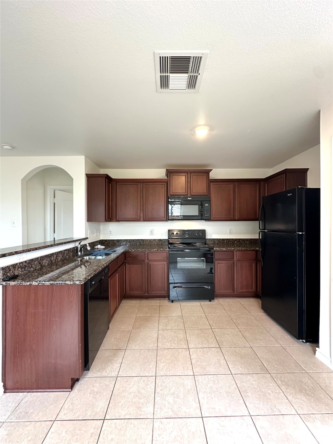 11203 Hall Ridge Court Houston, TX 77075 - Photo 4 of 21 a large kitchen with granite countertop a stove a sink dishwasher and a refrigerator