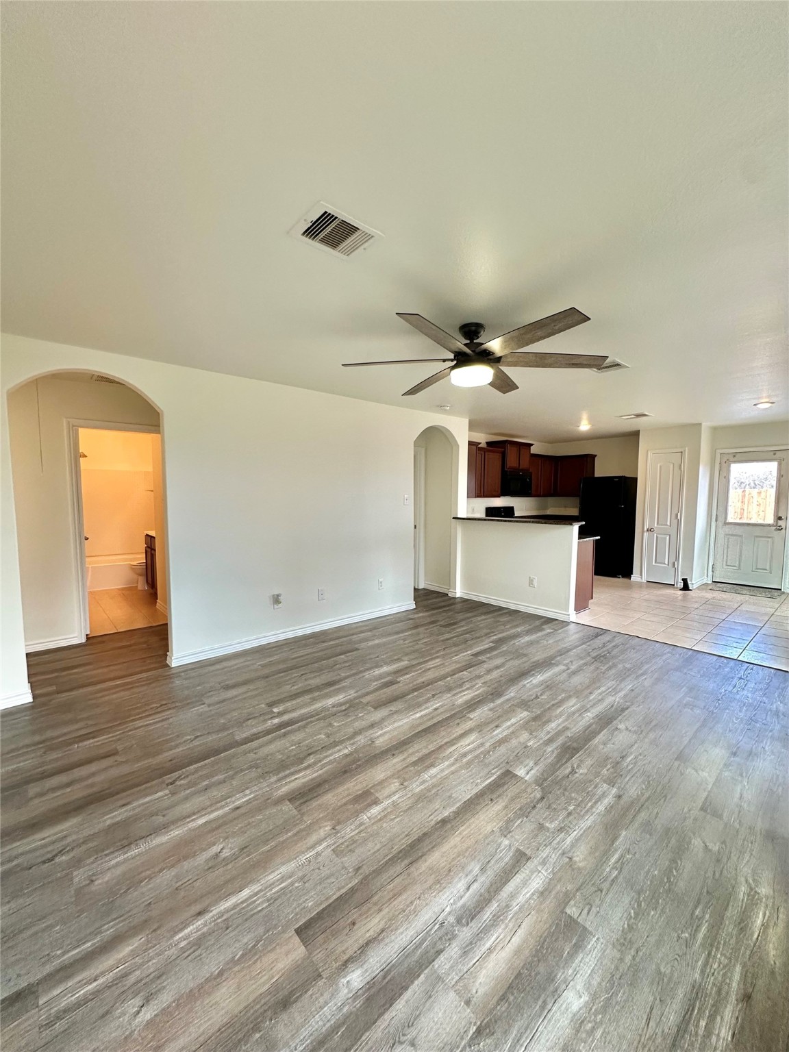 11203 Hall Ridge Court Houston, TX 77075 - Photo 7 of 21 an empty room with wooden floor and windows