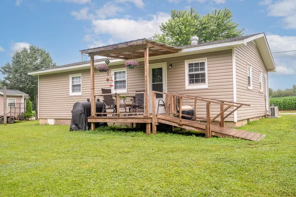 a view of a house with a yard and sitting area