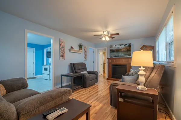 a living room with furniture a fireplace and a flat screen tv
