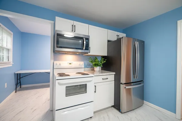 a kitchen with stainless steel appliances a refrigerator stove and microwave