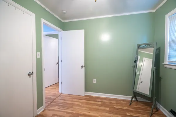 a view of a room with wooden floor