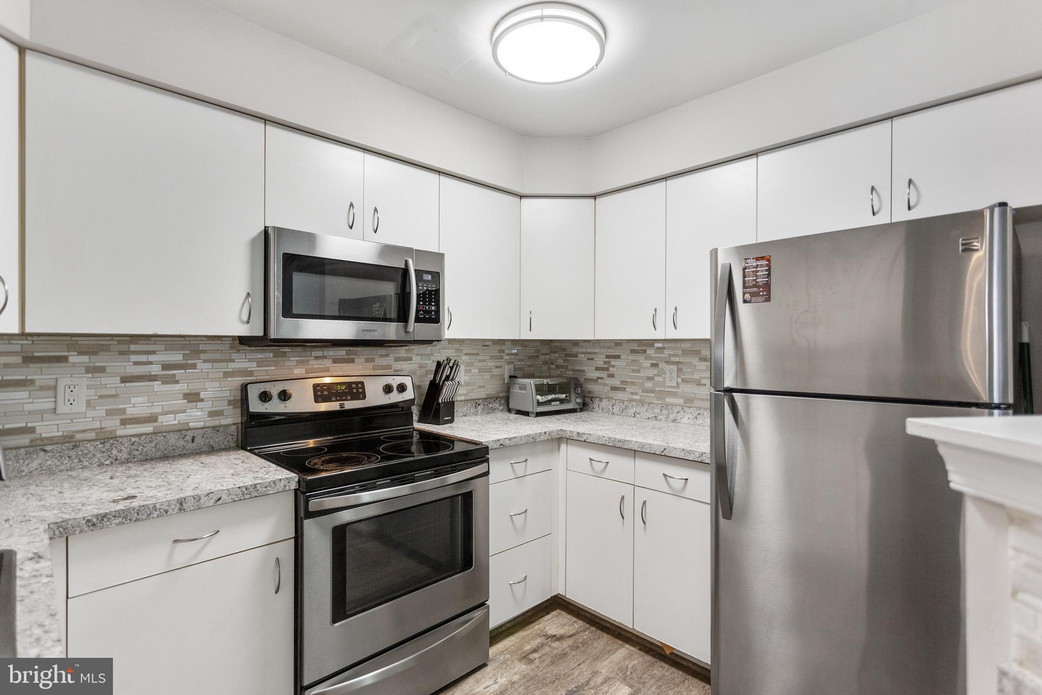 7638 Coachlight Lane Ellicott City, MD 21043 - Photo 11 of 22 Newer stainless steel appliances in kitchen