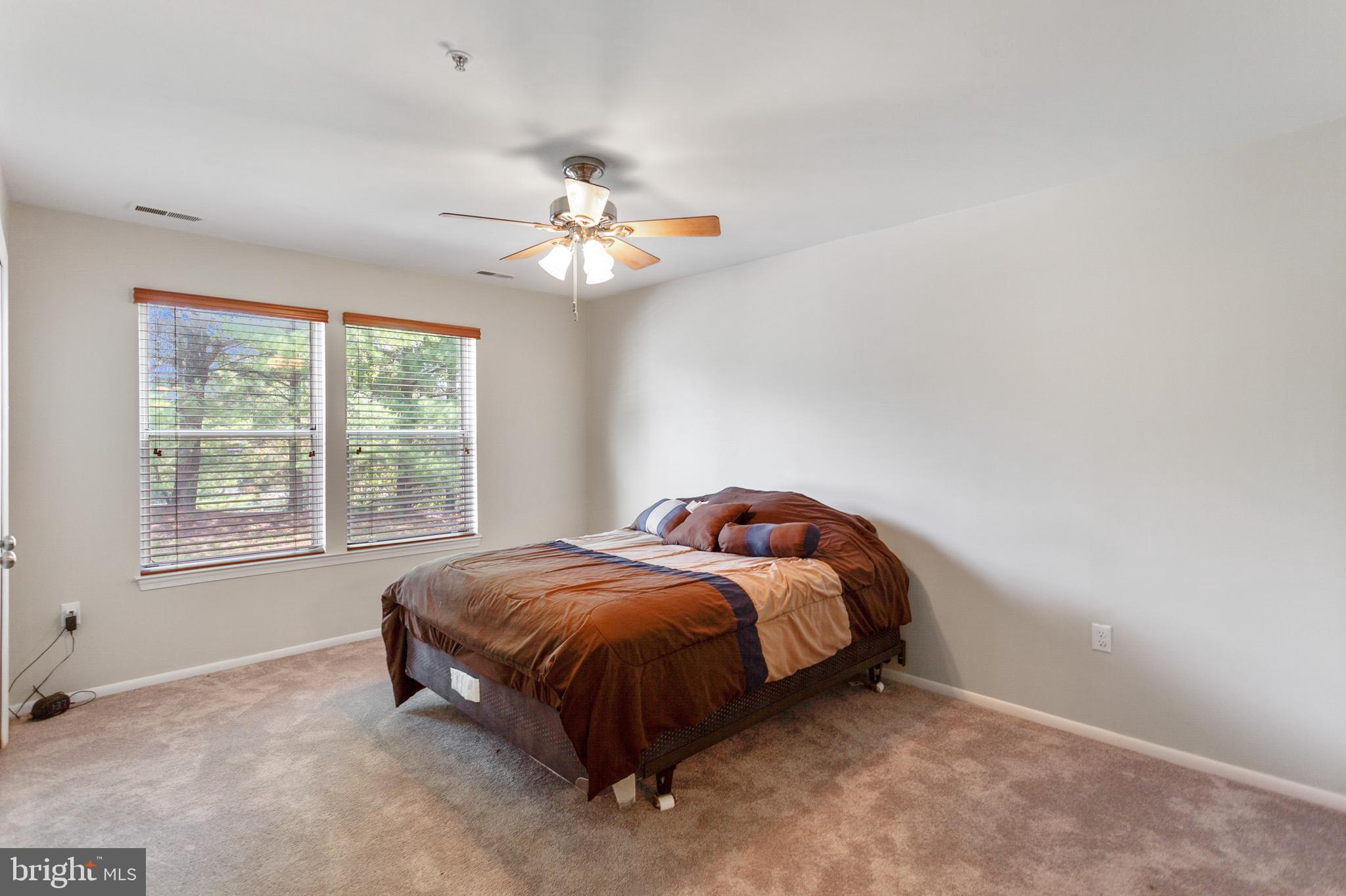 7638 Coachlight Lane Ellicott City, MD 21043 - Photo 16 of 22 Large master bedroom with ceiling fan & 2 closets