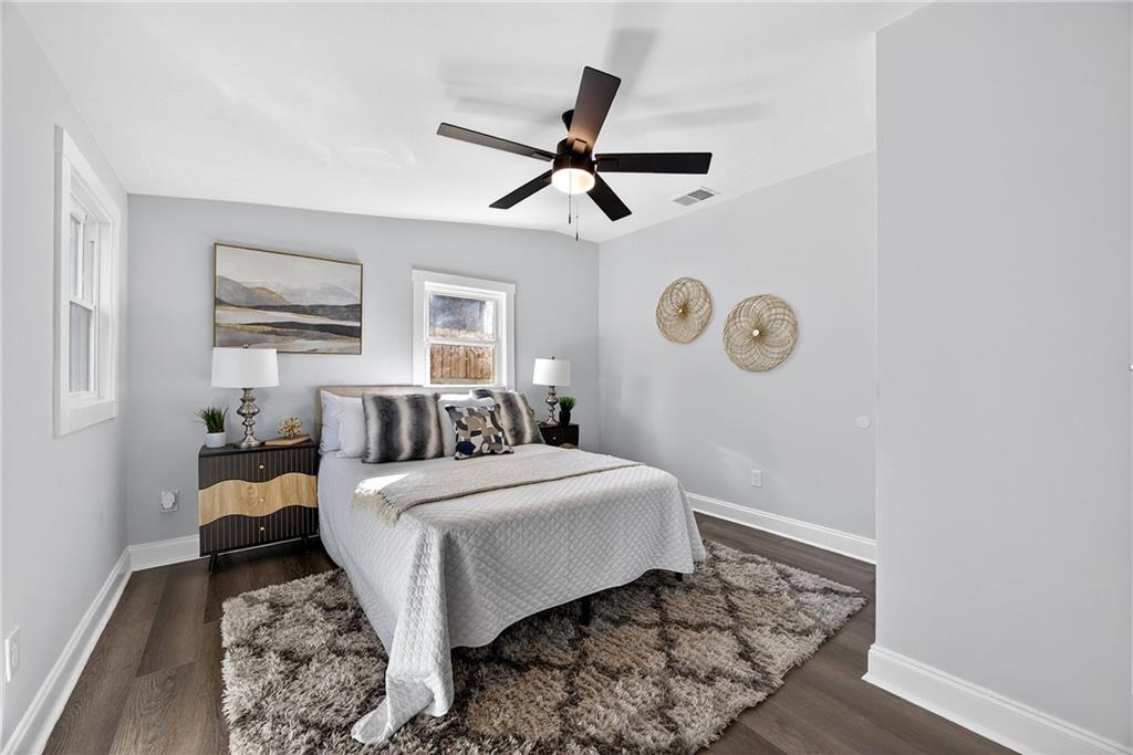 430 Wilkinson Drive Southeast Atlanta, GA 30317 - Photo 20 of 28 a bedroom with a bed and wooden floor