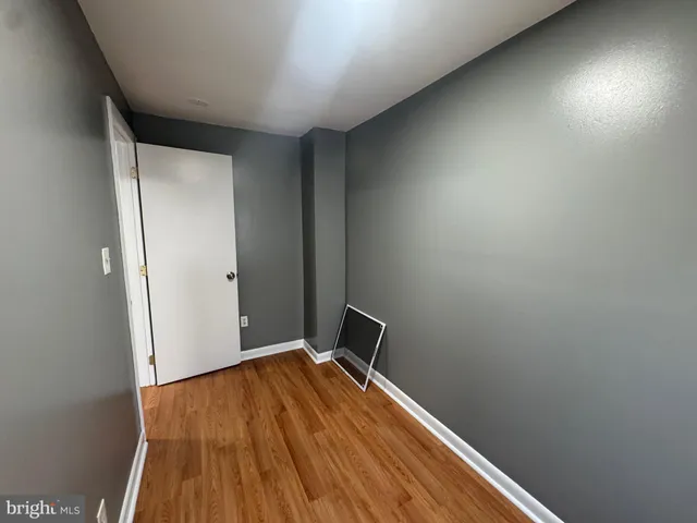 a view of a room with wooden floor