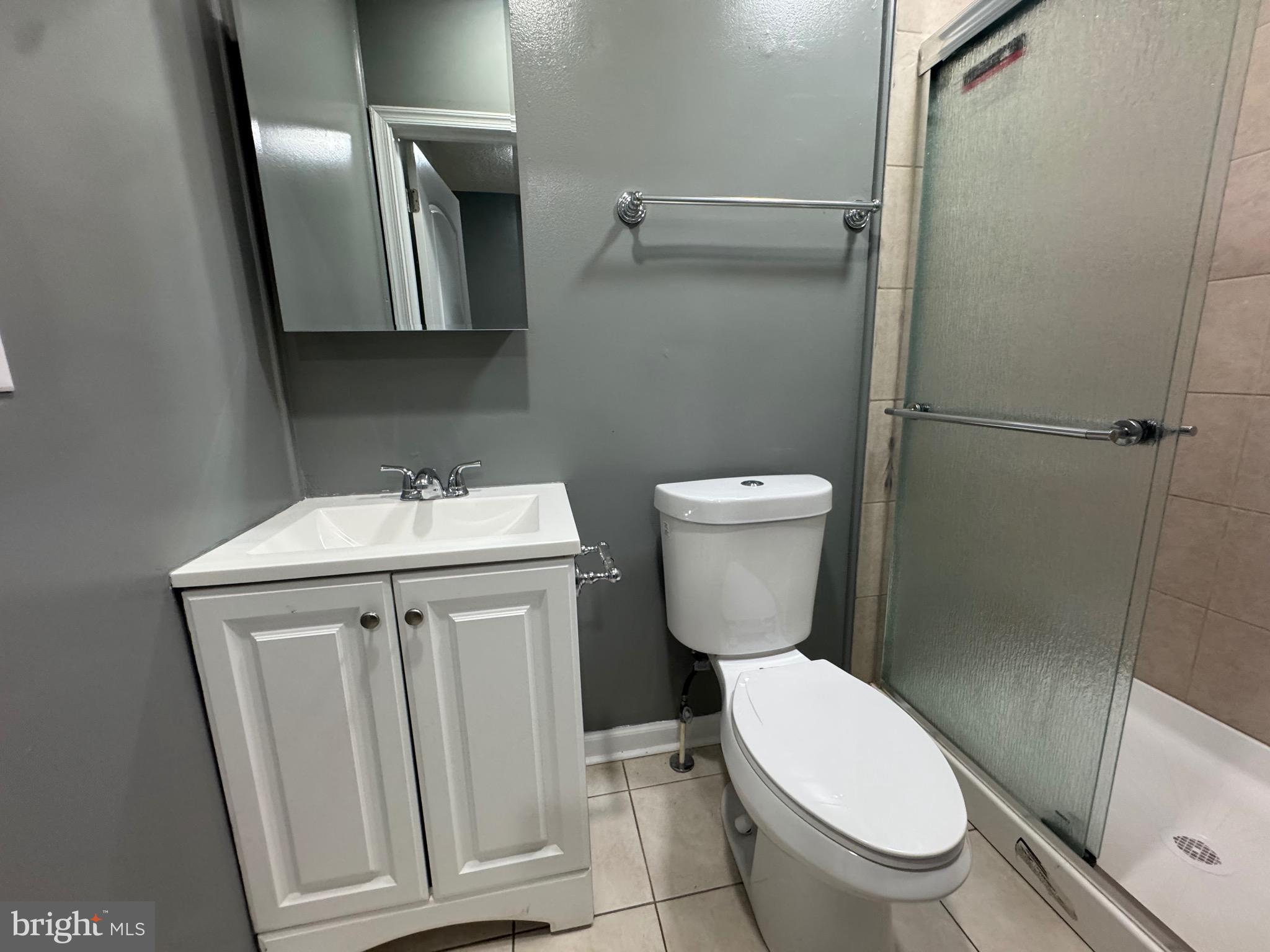 2408 Wilkens Avenue Baltimore, MD 21223 - Photo 19 of 26 a white toilet sitting next to a bathroom sink