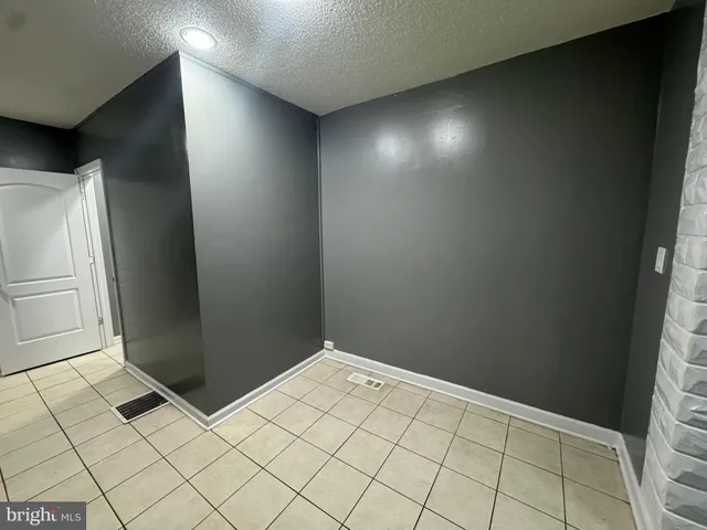 a kitchen with a refrigerator sink and cabinets