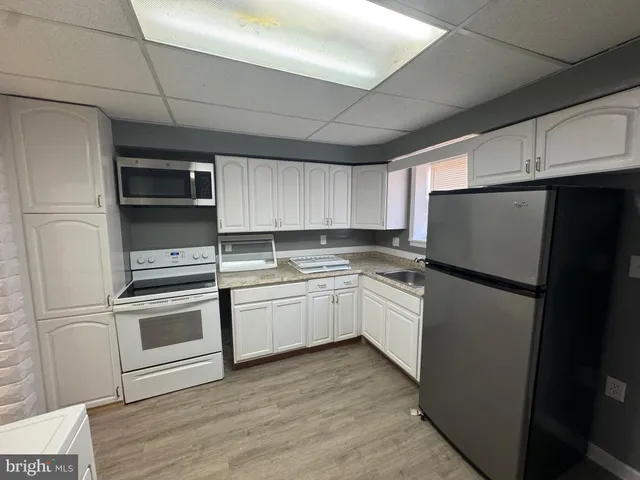 a kitchen with a refrigerator sink and microwave