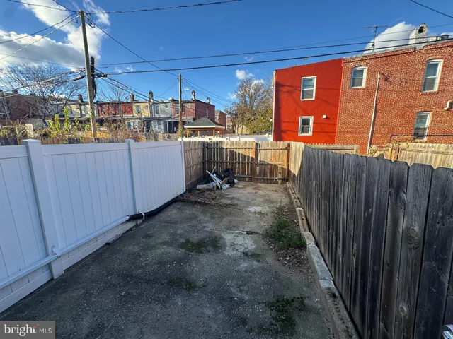 a view of a house with wooden fence