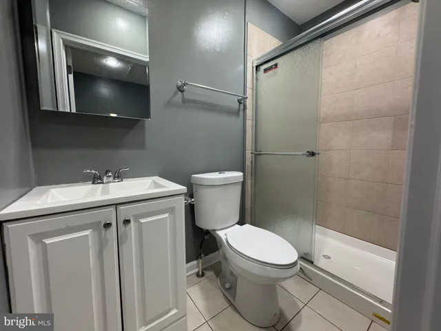 a bathroom with a toilet a sink and shower