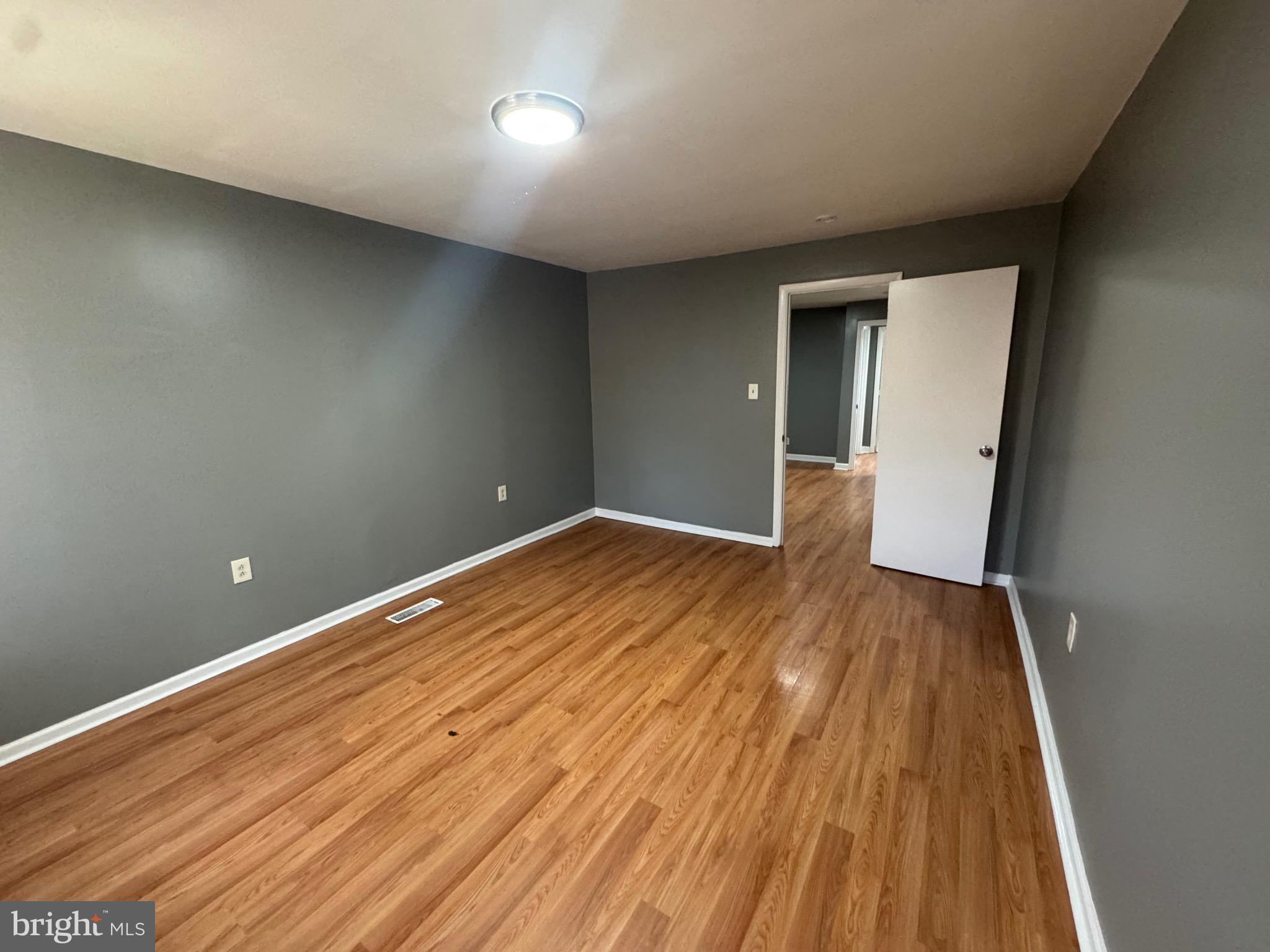 2408 Wilkens Avenue Baltimore, MD 21223 - Photo 4 of 26 a view of empty room with wooden floor