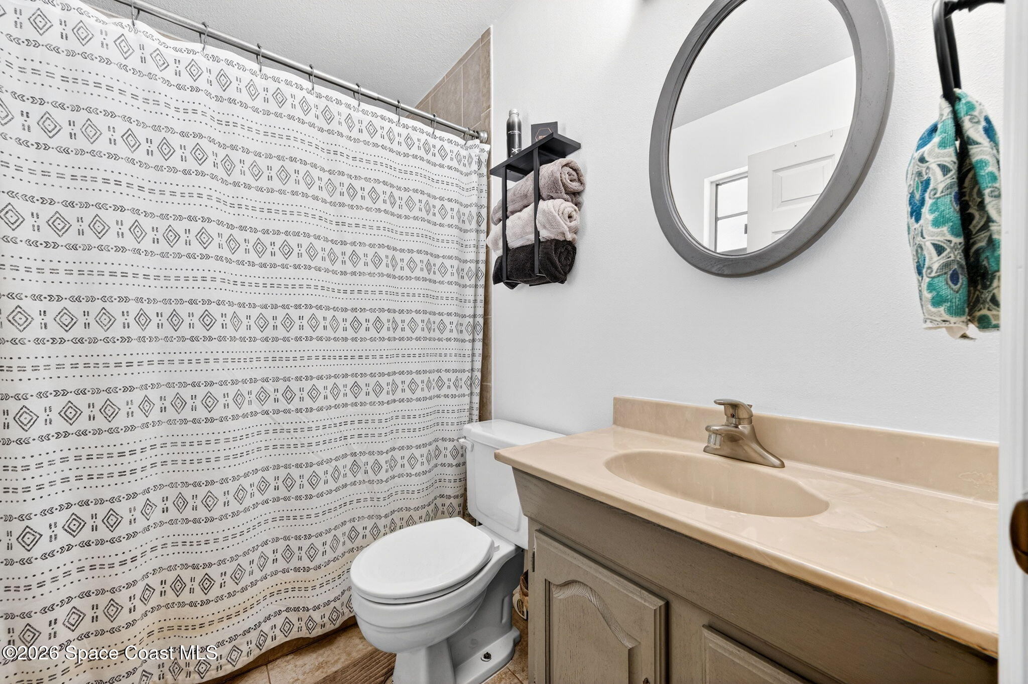 3300 Argyle Road Titusville, FL 32796 - Photo 21 of 29 a bathroom with a sink a toilet and a mirror