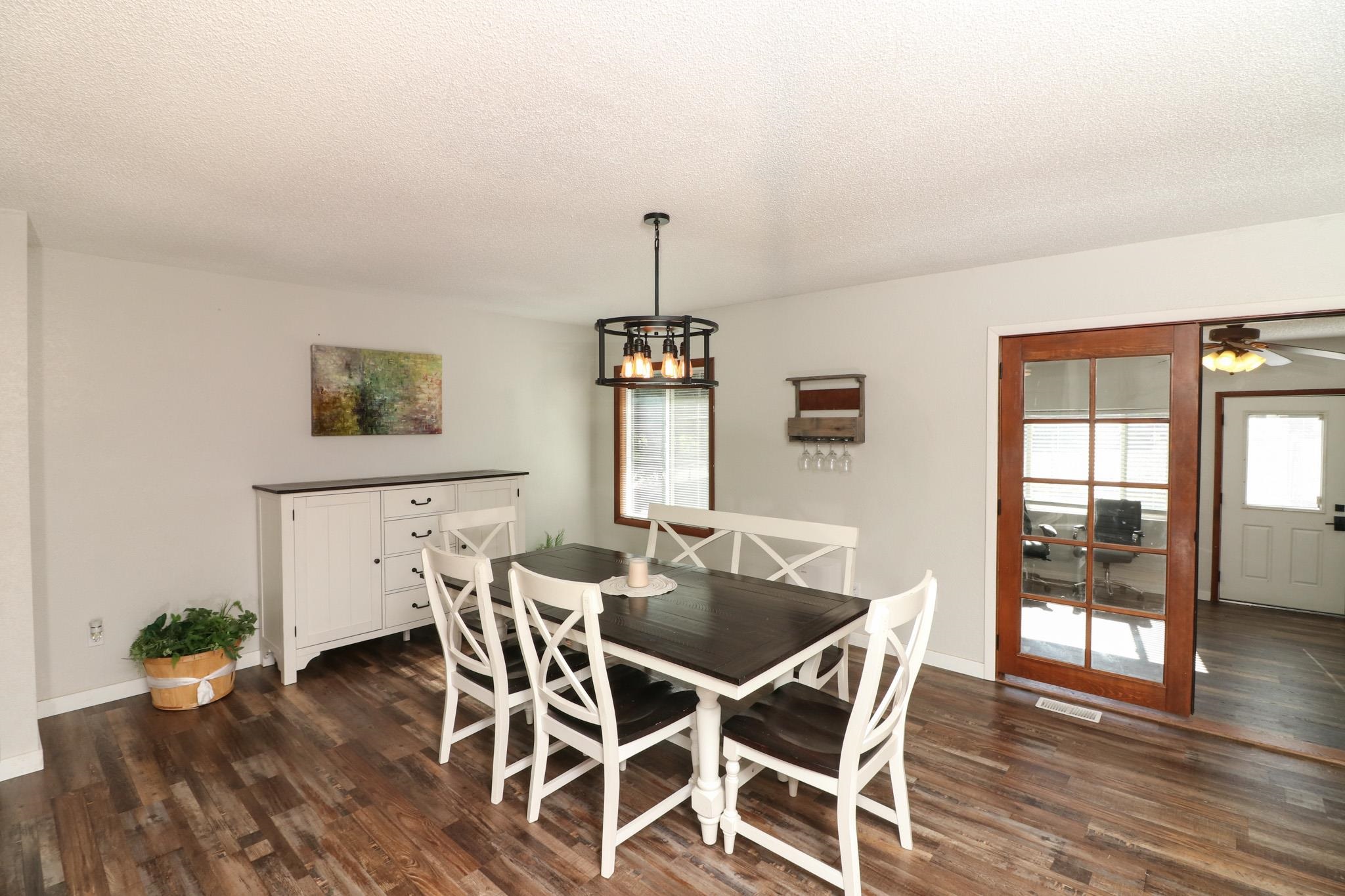 607-28 28 3/4 Road Grand Junction, CO 81506 - Photo 9 of 42 a view of a dining room with furniture window and wooden floor