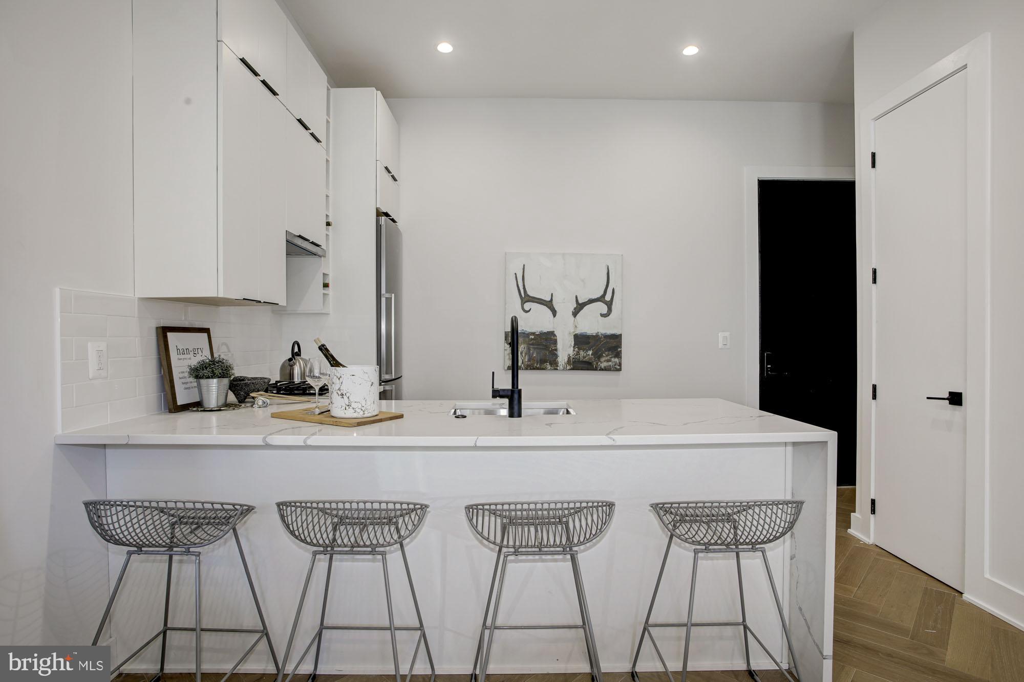 1225 11th Street Northwest, Unit 6 Washington, DC 20001 - Photo 1 of 15 a kitchen with stainless steel appliances a sink and cabinets