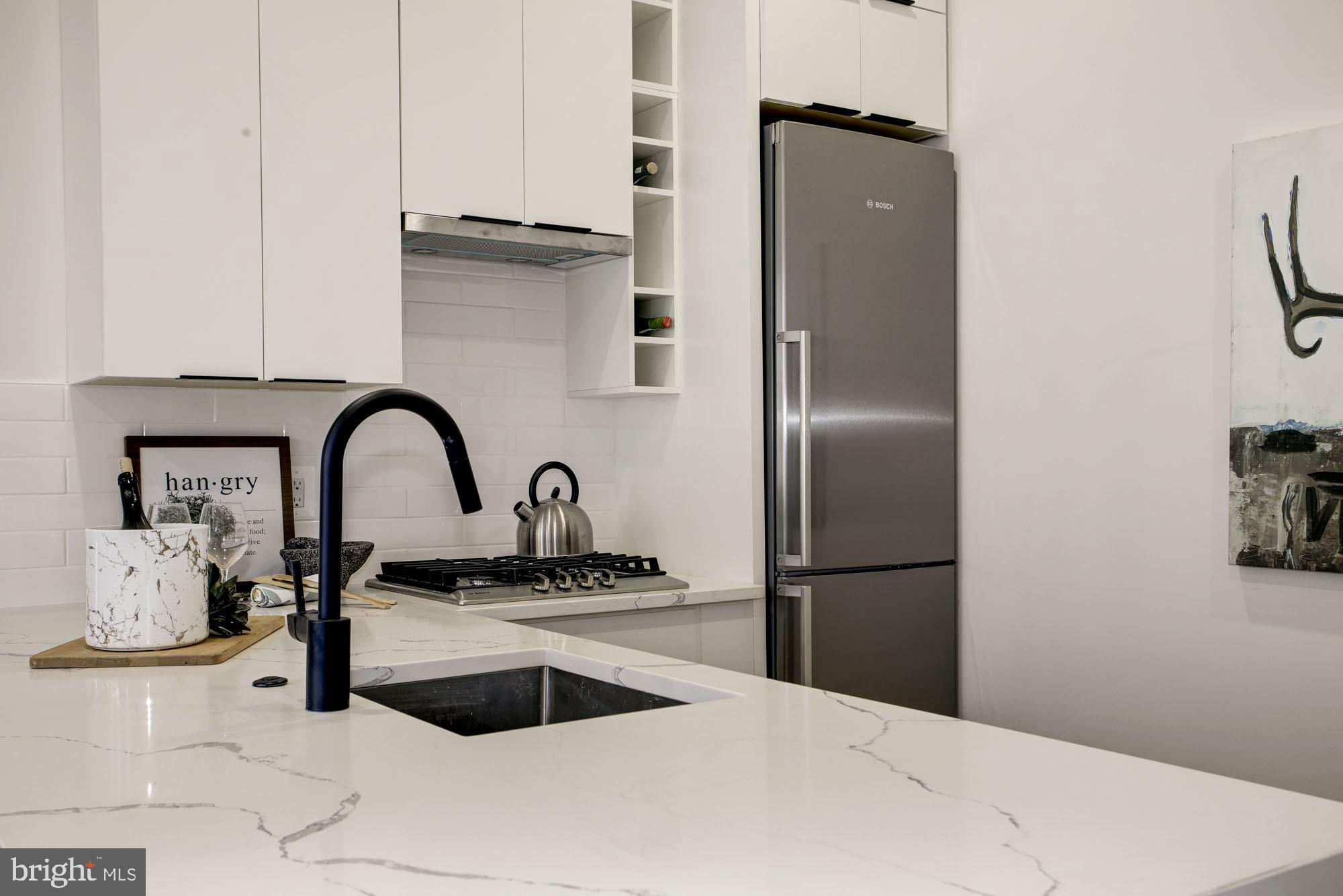 1225 11th Street Northwest, Unit 6 Washington, DC 20001 - Photo 2 of 15 a kitchen with a refrigerator and a stove top oven