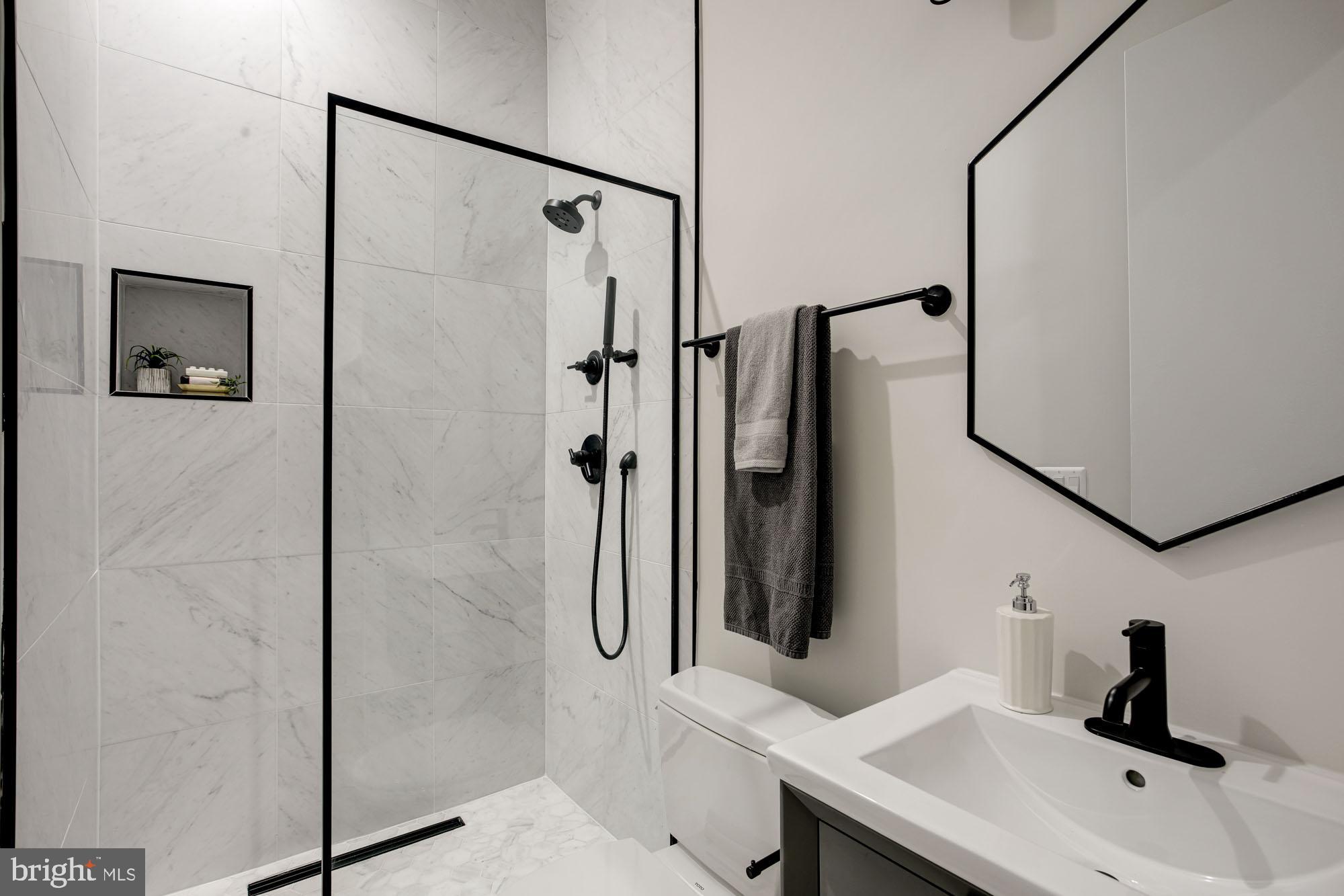 1225 11th Street Northwest, Unit 6 Washington, DC 20001 - Photo 7 of 15 a bathroom with a sink and a mirror