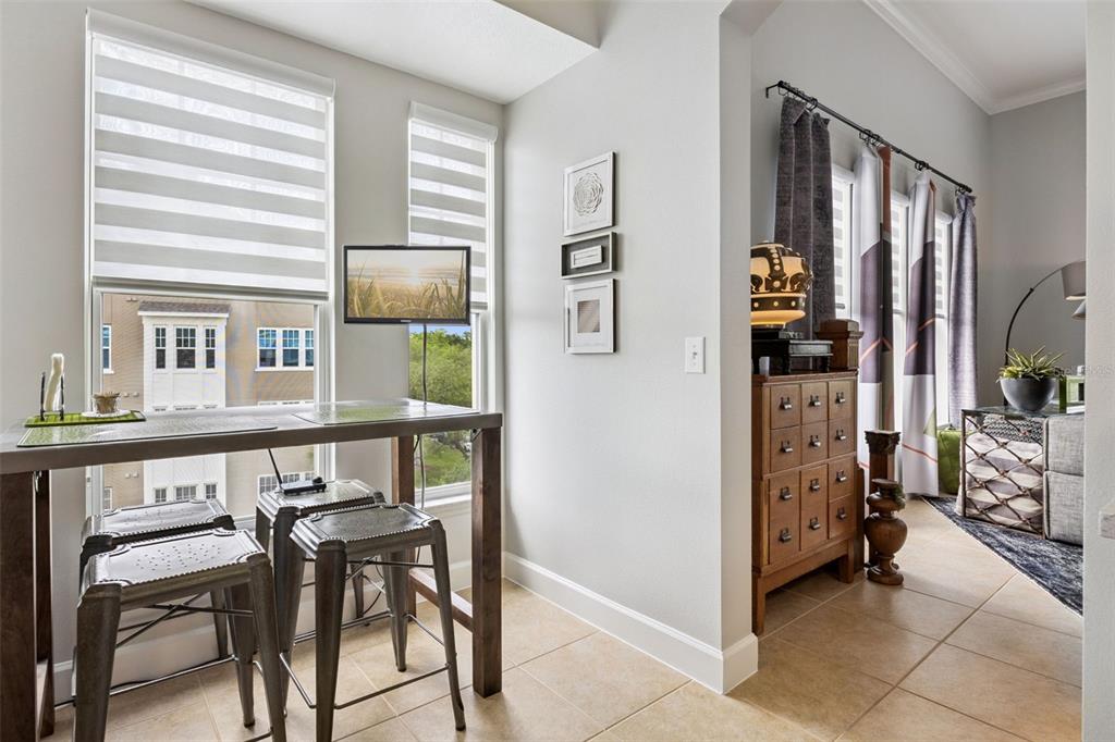 1400 Celebration Avenue, Unit 401 Celebration, FL 34747 - Photo 15 of 68 a view of a dining room with furniture and windows