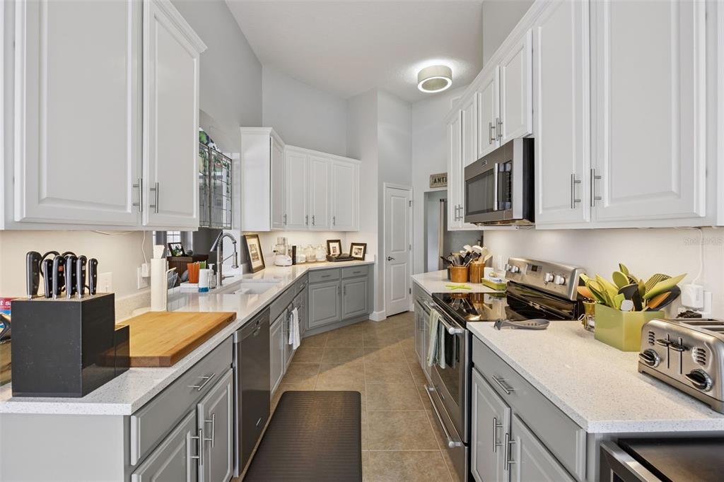 1400 Celebration Avenue, Unit 401 Celebration, FL 34747 - Photo 20 of 68 a kitchen with stainless steel appliances granite countertop a stove a sink dishwasher and a refrigerator