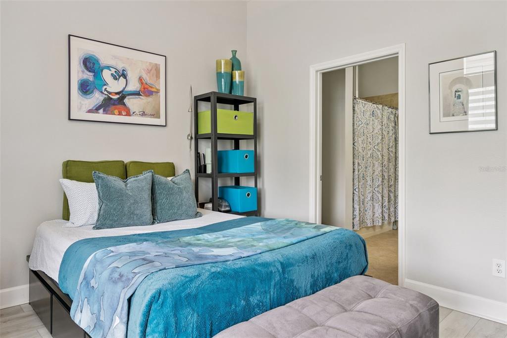 1400 Celebration Avenue, Unit 401 Celebration, FL 34747 - Photo 22 of 68 a bedroom with a bed and painting on the wall