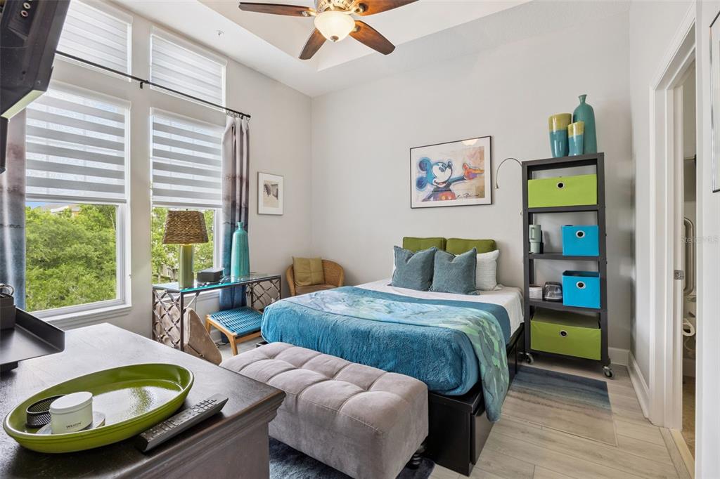 1400 Celebration Avenue, Unit 401 Celebration, FL 34747 - Photo 23 of 68 a bedroom with a bed and a large window