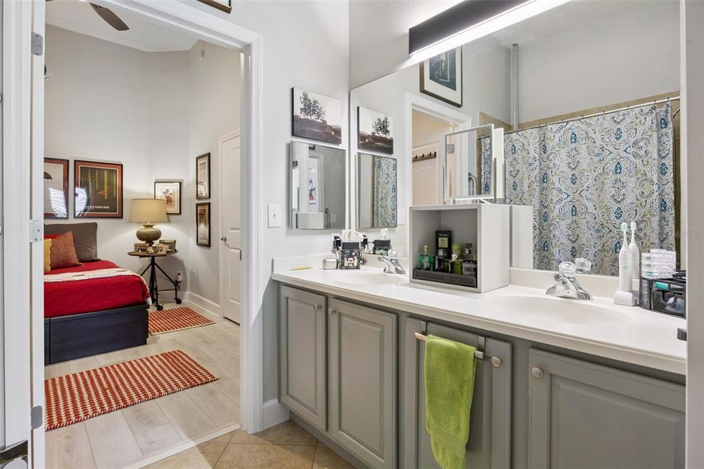 1400 Celebration Avenue, Unit 401 Celebration, FL 34747 - Photo 24 of 68 a spacious bathroom with a sink double vanity and a mirror