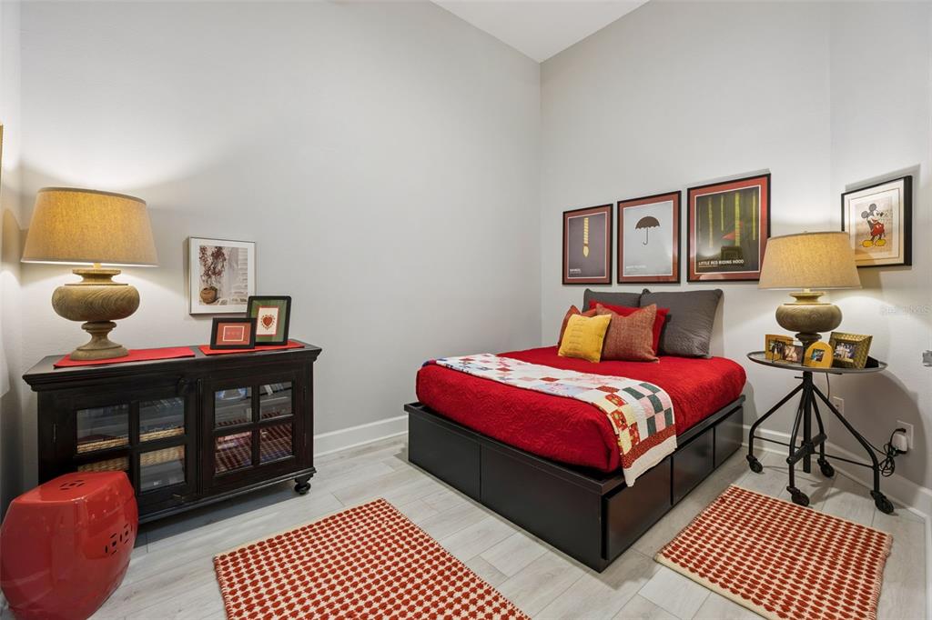 1400 Celebration Avenue, Unit 401 Celebration, FL 34747 - Photo 25 of 68 a bedroom with a bed and wooden floor