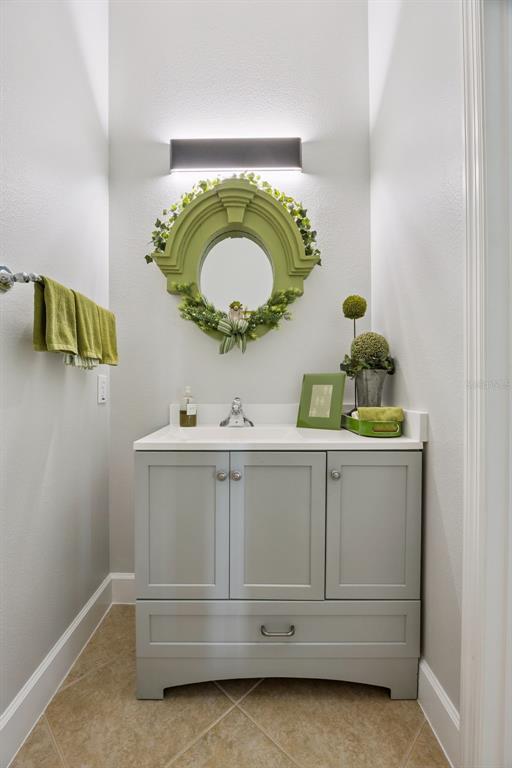1400 Celebration Avenue, Unit 401 Celebration, FL 34747 - Photo 27 of 68 a bathroom with a sink and a mirror