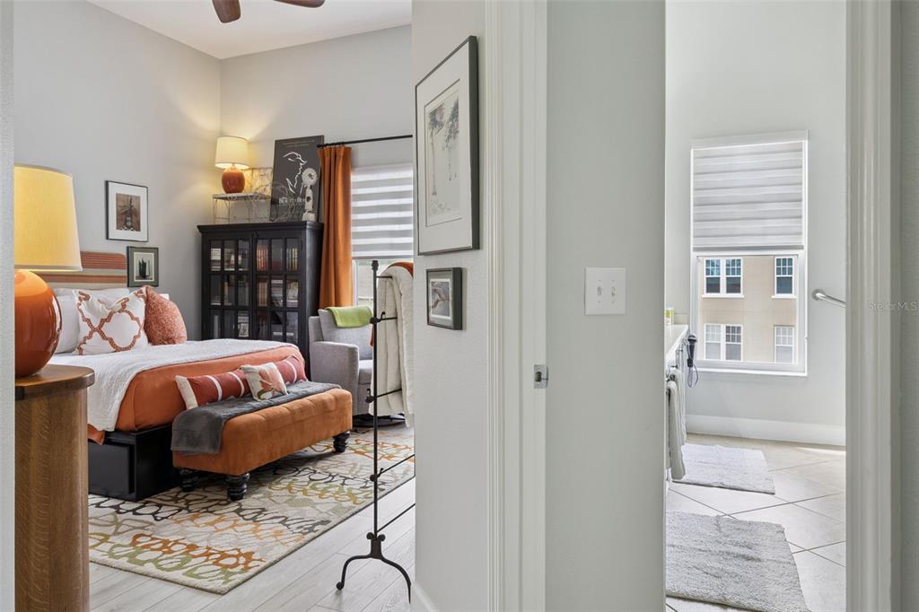 1400 Celebration Avenue, Unit 401 Celebration, FL 34747 - Photo 28 of 68 a bedroom with a bed and wooden floor