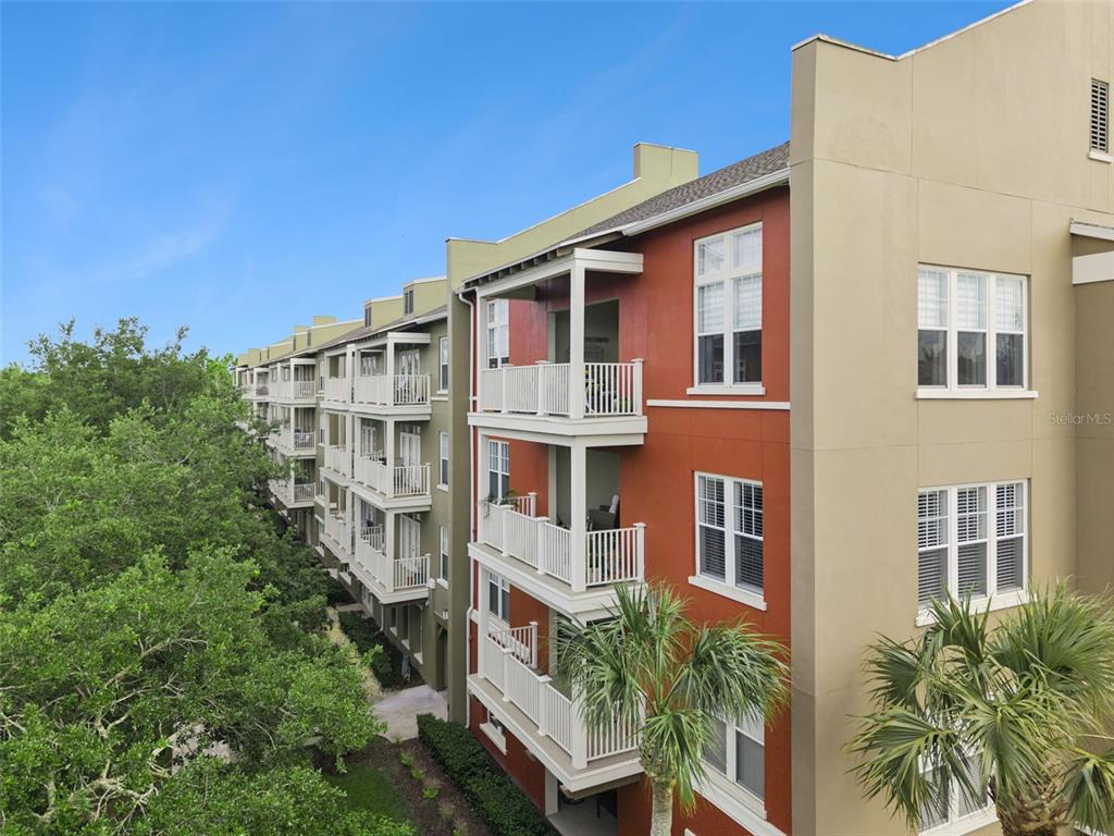 1400 Celebration Avenue, Unit 401 Celebration, FL 34747 - Photo 3 of 68 a view of a building with a yard