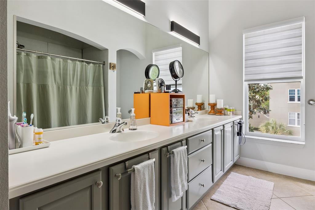 1400 Celebration Avenue, Unit 401 Celebration, FL 34747 - Photo 32 of 68 a bathroom with a sink and a mirror