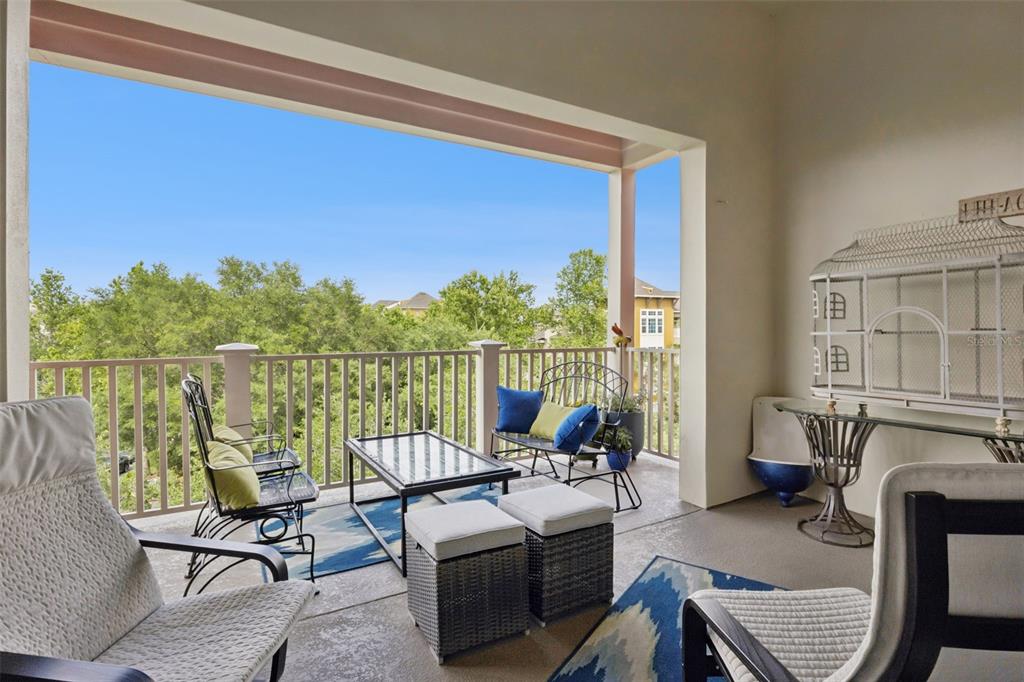 1400 Celebration Avenue, Unit 401 Celebration, FL 34747 - Photo 36 of 68 a living room with furniture a fireplace and a floor to ceiling window