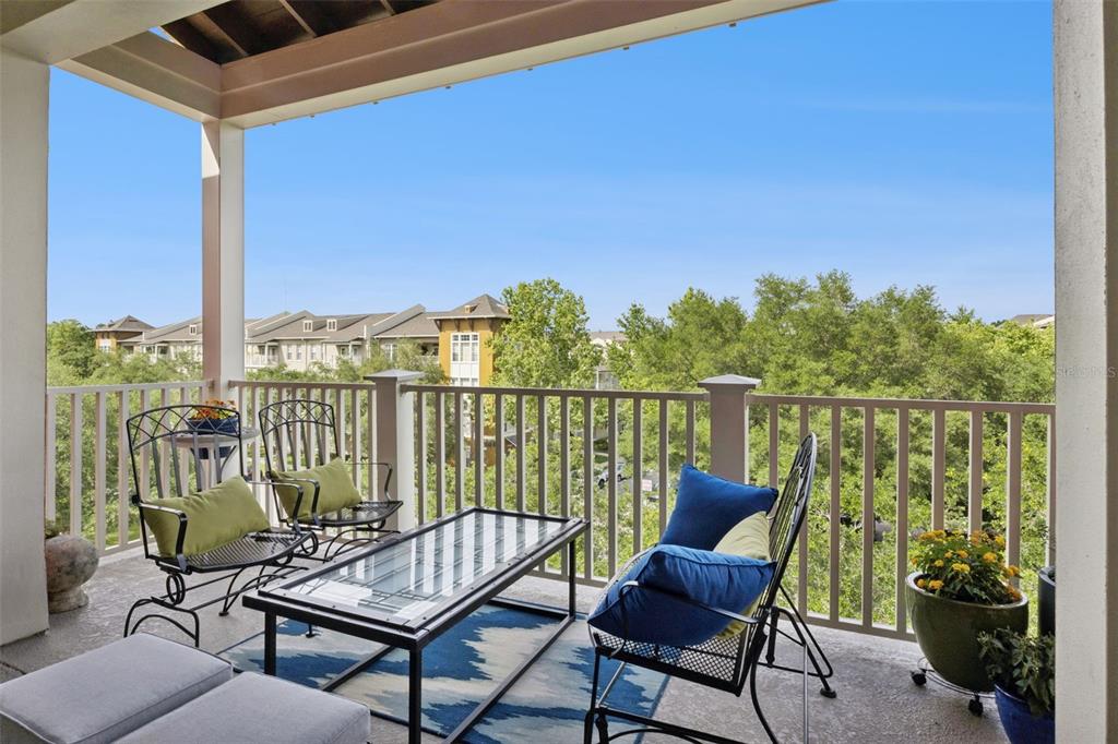 1400 Celebration Avenue, Unit 401 Celebration, FL 34747 - Photo 37 of 68 a view of a chair and table in the balcony