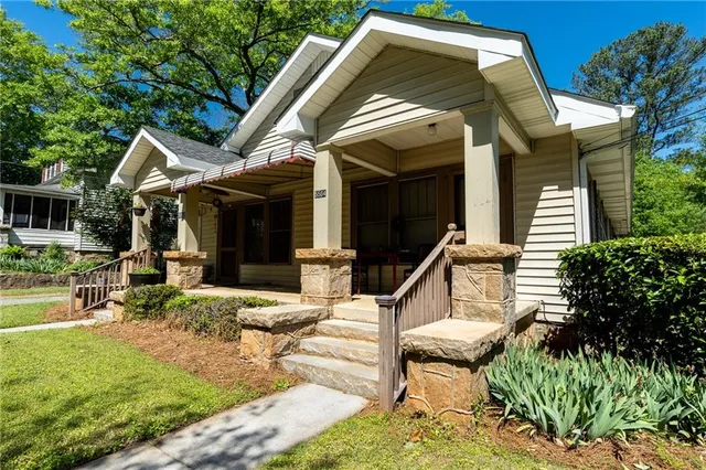 a view of house with backyard and sitting area