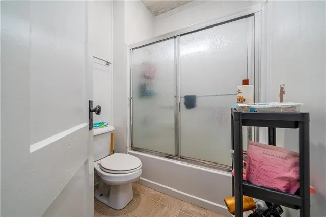 a bathroom with a toilet a sink and shower