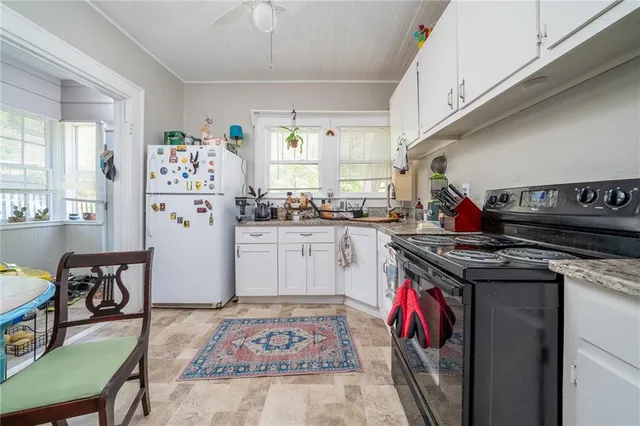 a kitchen with a stove a refrigerator and a dining table