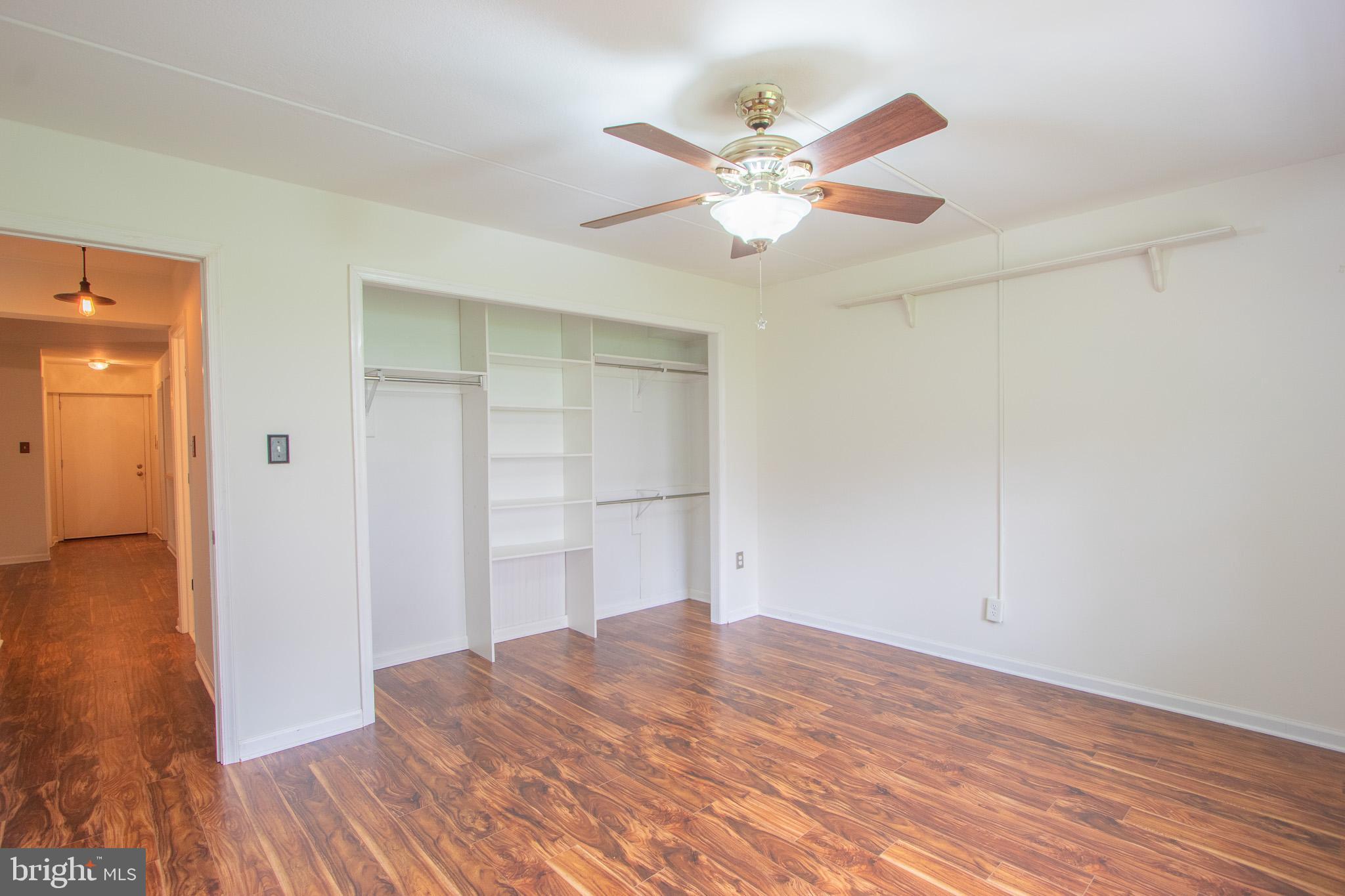 76 Welsh Tract Road, Unit F109 Newark, DE 19713 - Photo 25 of 31 a view of a room with wooden floor and closet area