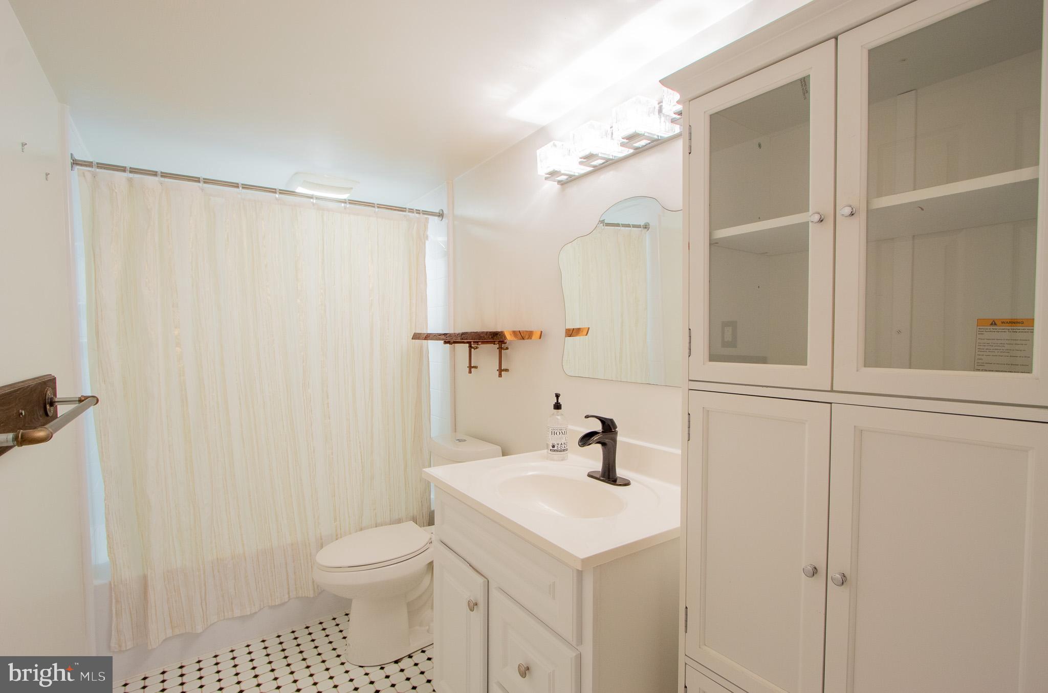 76 Welsh Tract Road, Unit F109 Newark, DE 19713 - Photo 28 of 31 a bathroom with a sink a toilet and shower
