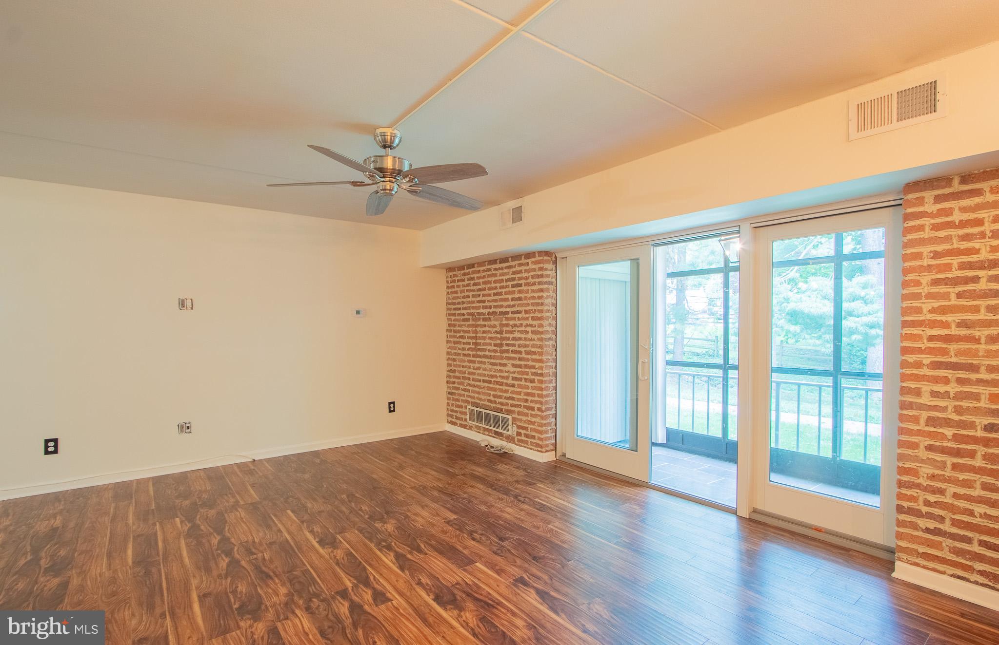 76 Welsh Tract Road, Unit F109 Newark, DE 19713 - Photo 4 of 31 wooden floor in an empty room with a window