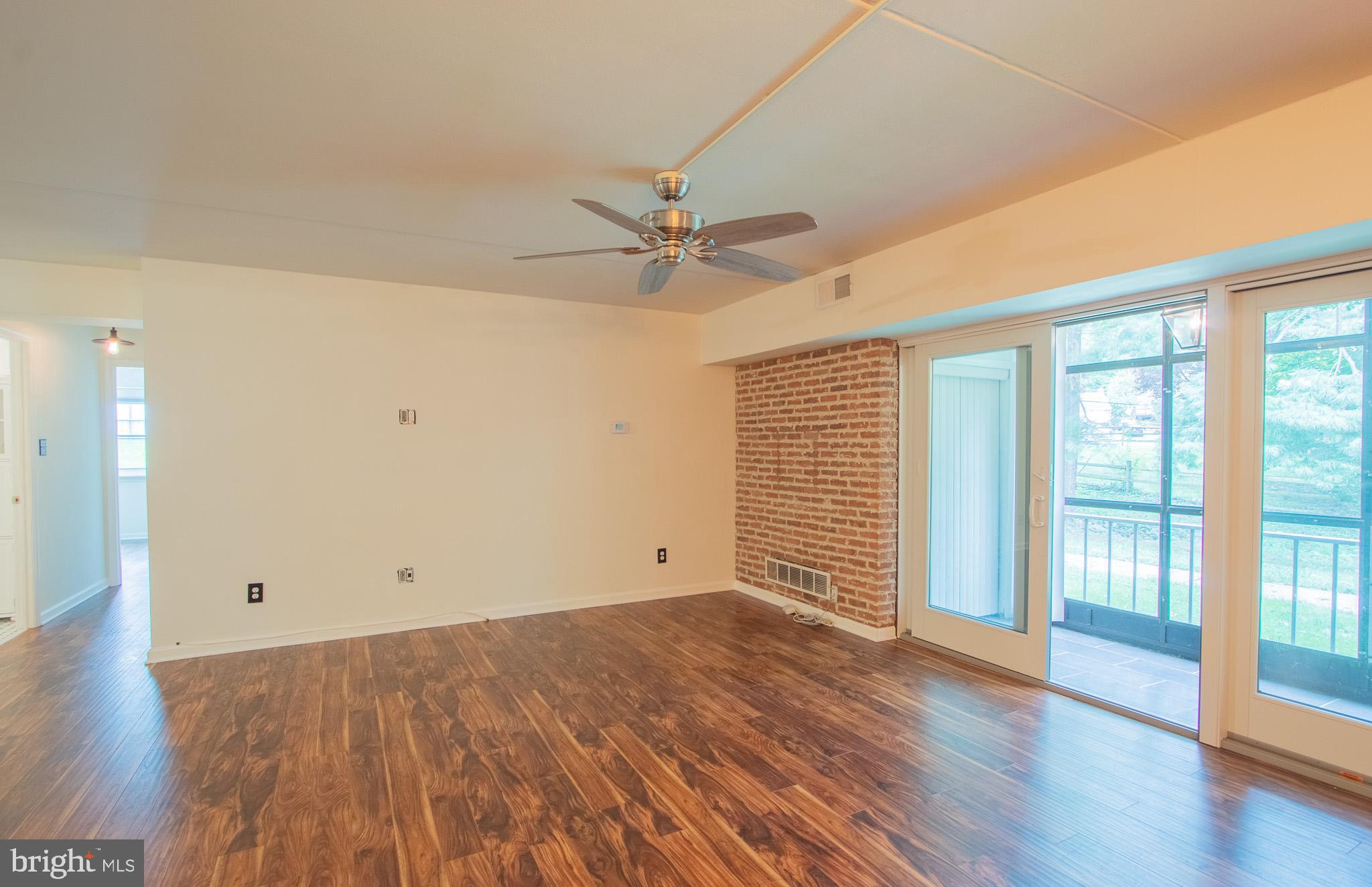 76 Welsh Tract Road, Unit F109 Newark, DE 19713 - Photo 6 of 31 an empty room with wooden floor and windows