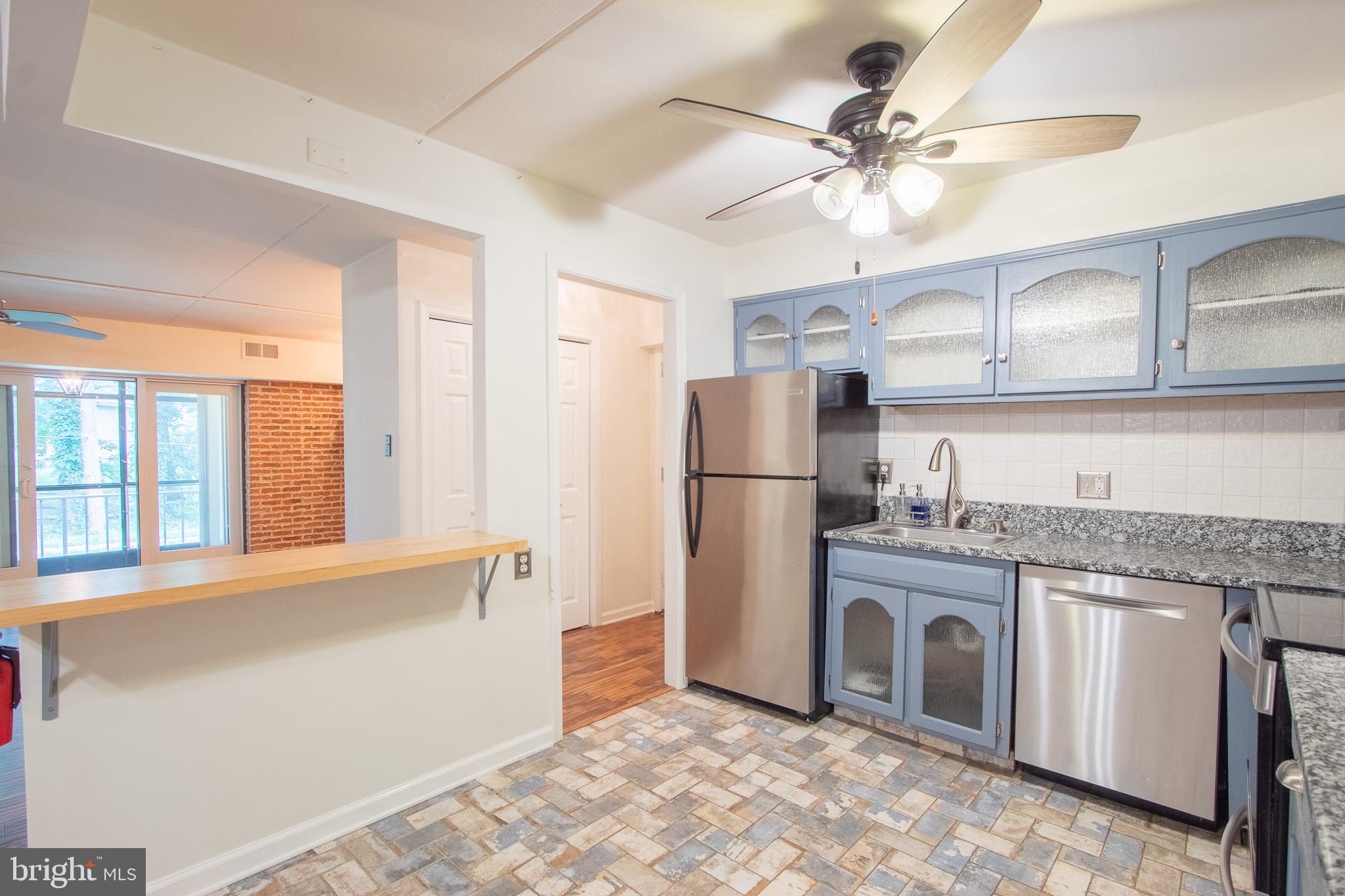 76 Welsh Tract Road, Unit F109 Newark, DE 19713 - Photo 7 of 31 a kitchen with a refrigerator a sink and dishwasher