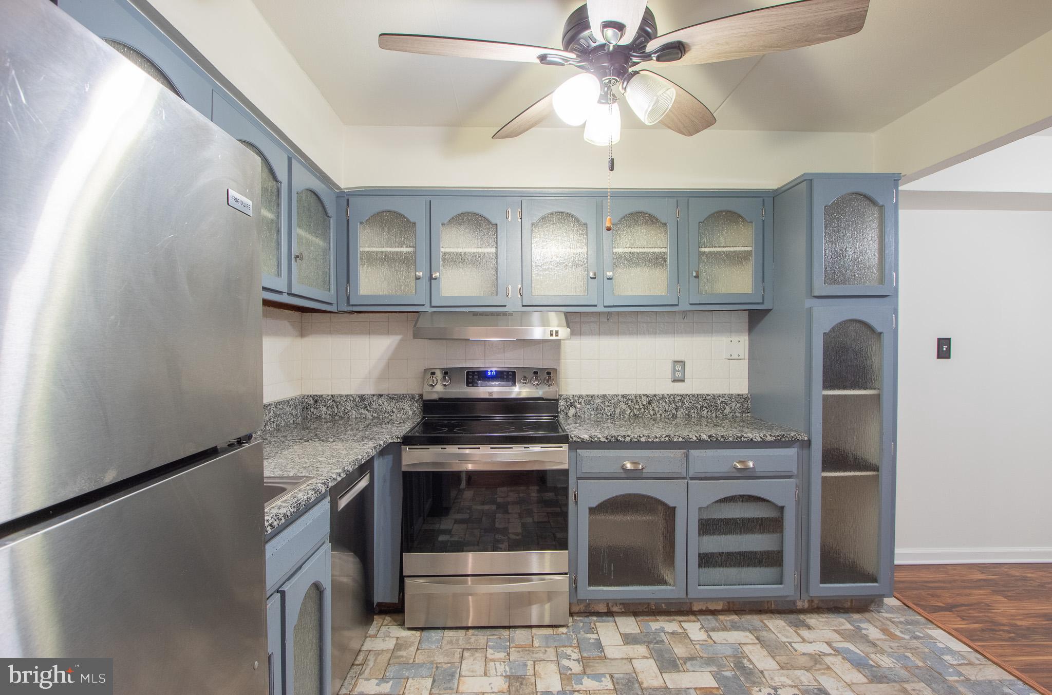 76 Welsh Tract Road, Unit F109 Newark, DE 19713 - Photo 10 of 31 a kitchen with stainless steel appliances granite countertop a stove and a sink