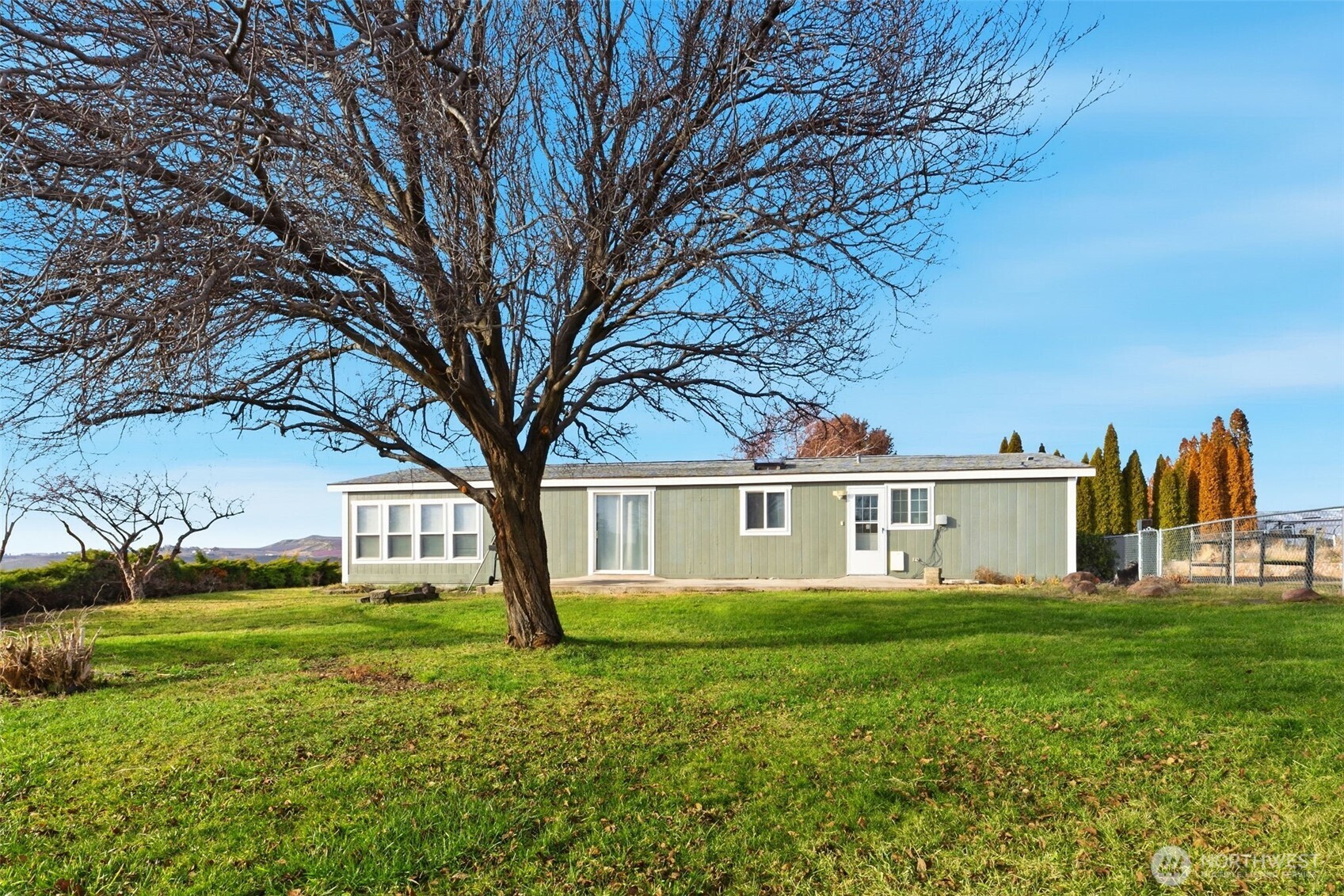 401 Clemans View Road Selah, WA 98942 - Photo 7 of 28 a view of a house with a big yard and large trees